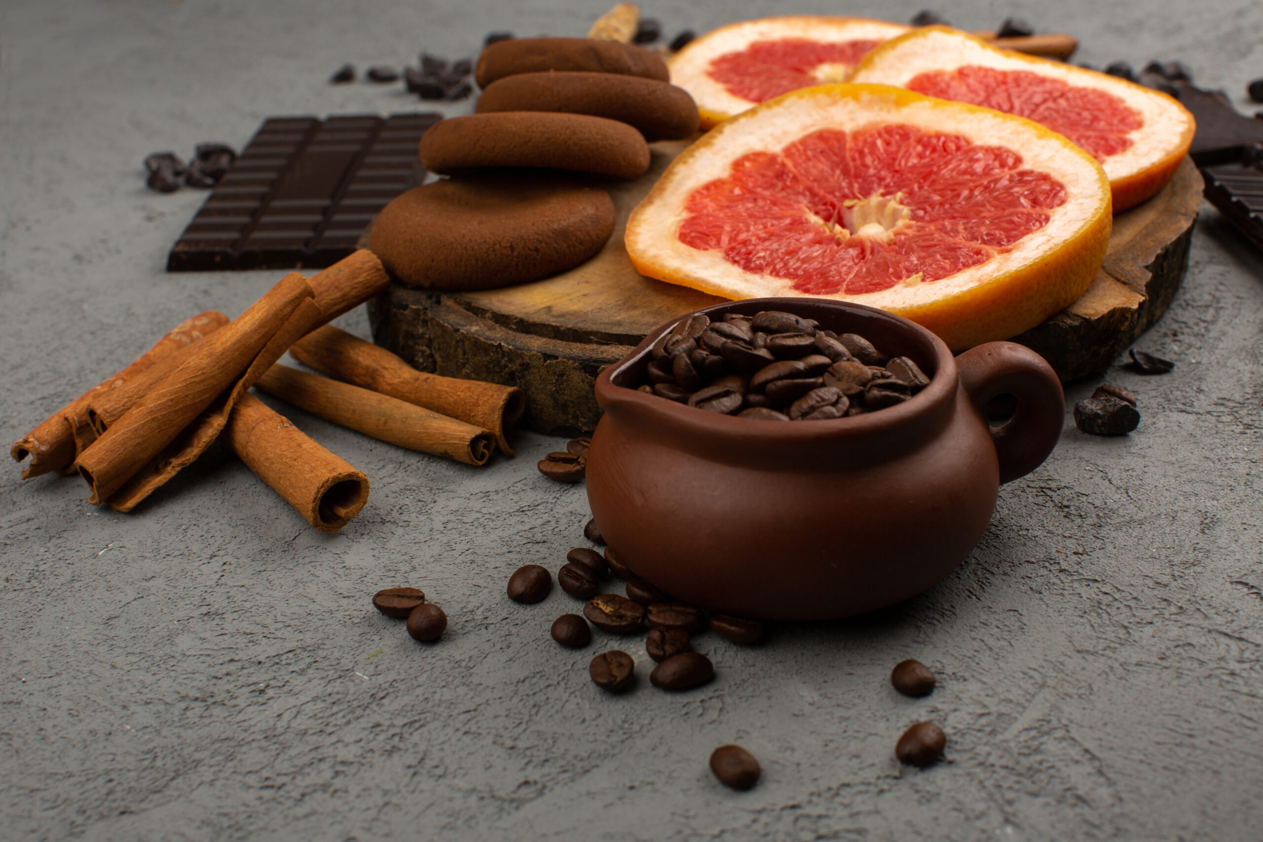 top-view-grapefruits-cookies-cinnamon-along-with-brown-coffee-seeds-grey-floor